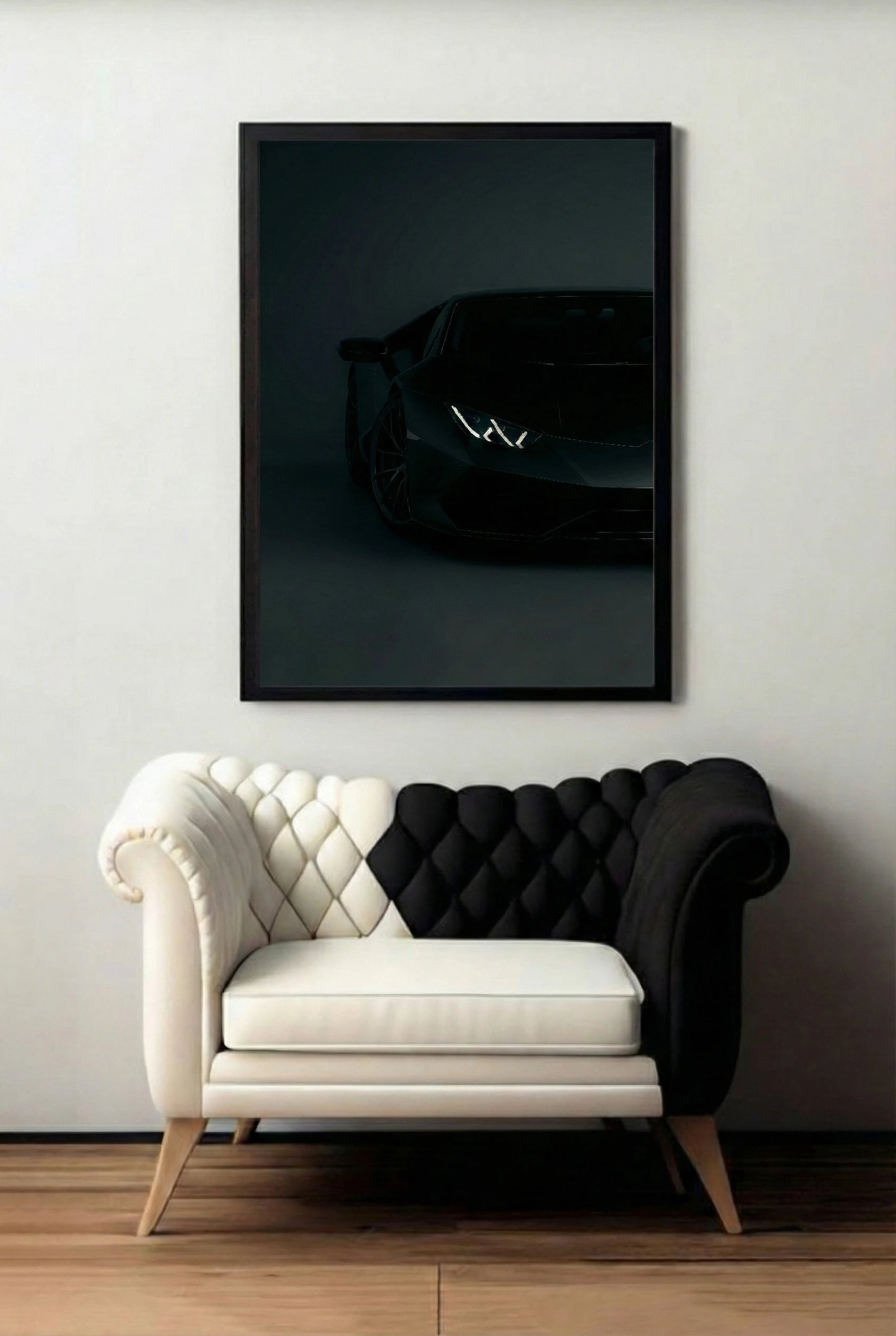 Framed black Supercar art piece on a wall above a modern black and white sofa.