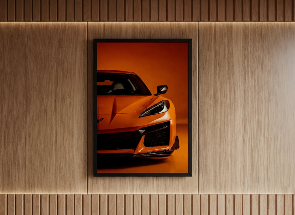 Framed poster of a sports car on an orange background, mounted on a wooden wall for boys room.