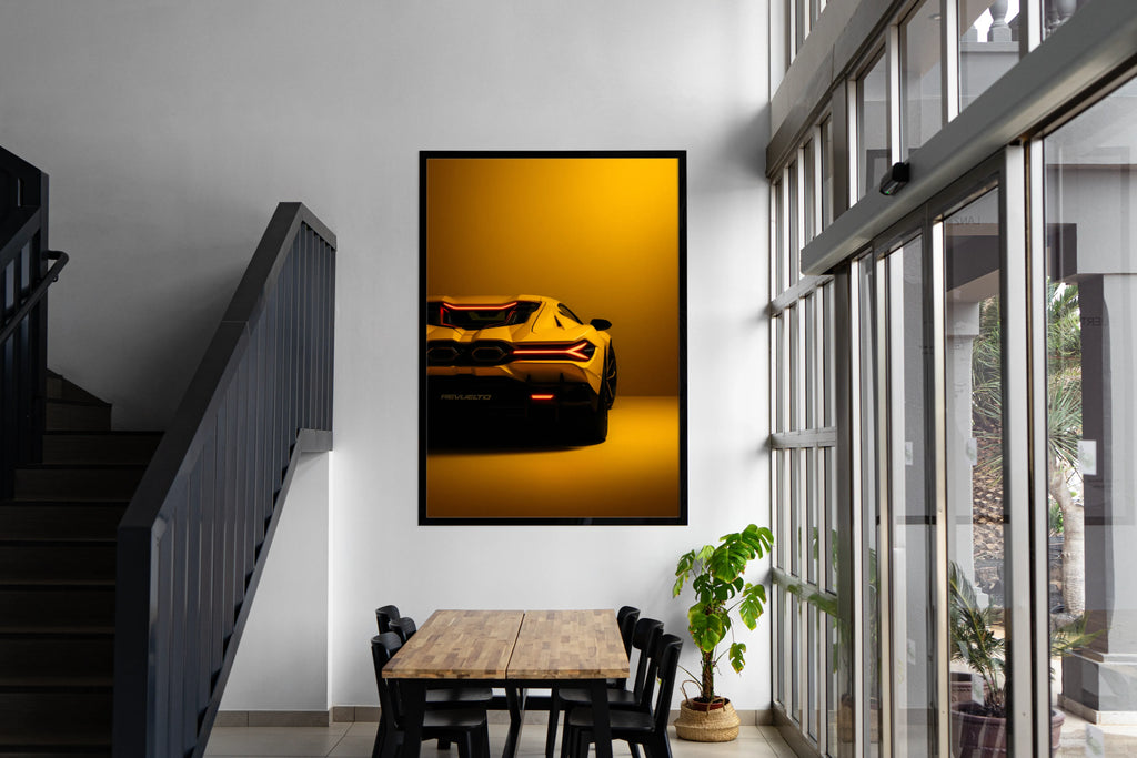 Framed picture of a yellow sports car on a wall in a modern interior setting.